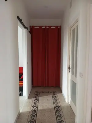 a red shower curtain in a room with a door at Cozy Room in Rome