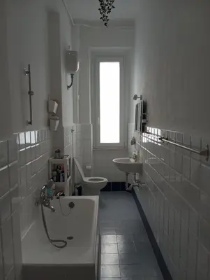 a bathroom with a tub and a toilet and a sink at Cozy Room in Rome