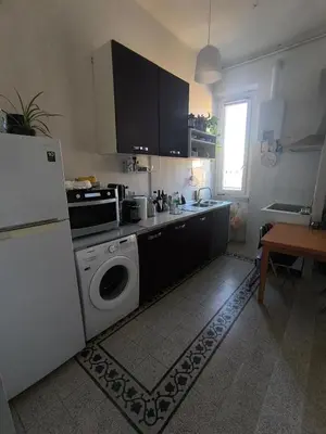 a kitchen with a refrigerator and a washing machine at Cozy Room in Rome