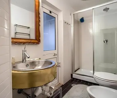 a bathroom with a sink and a toilet at Casa Roma in Rome