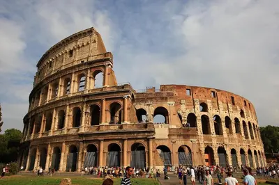 a group of people standing in front of the coliseum at Casa Roma in Rome