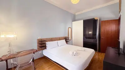 a small bedroom with a white bed and a desk at Domus Leonis in Rome