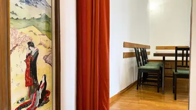 a room with a painting and a table and a chair at Domus Leonis in Rome
