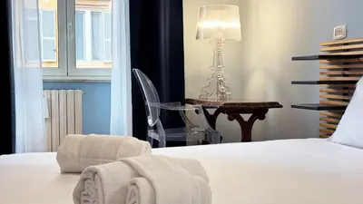a bedroom with a bed and a chair and a table at Domus Leonis in Rome