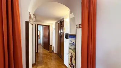 a hallway with an archway and orange curtains at Domus Leonis in Rome