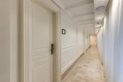 a corridor with white walls and a door at ACA Hotel Viminale in Rome