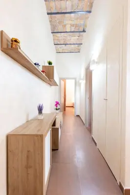a kitchen with white walls and a wooden counter at Albio House - Nido Per 6PPL 3BTH in Rome