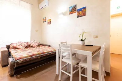 a room with a table and a bed and a table and chairs at Albio House - Nido Per 6PPL 3BTH in Rome