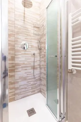 a bathroom with a shower with a glass door at Albio House - Nido Per 6PPL 3BTH in Rome