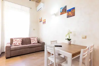 a living room with a table and a couch at Albio House - Nido Per 6PPL 3BTH in Rome