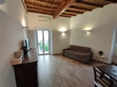 a living room with a couch and a table at House Moro in Rome