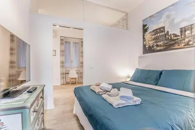 a bedroom with a blue bed with towels on it at Vatican Chic House II in Rome