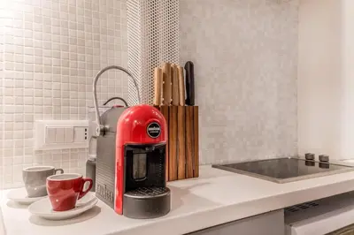 a red coffee maker sitting on a kitchen counter at Vatican Chic House II in Rome