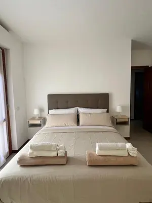 a bedroom with a large bed with two towels on it at The BestaHouse in Rome