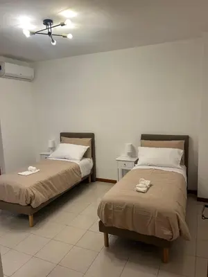 two beds sitting next to each other in a room at The BestaHouse in Rome