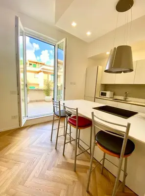 a kitchen with a table and chairs and a large window at Spacious Apartment with Outdoor Terrace near Vatican - Casa Vacanze Romane in Rome