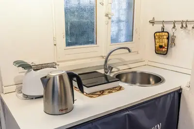 a kitchen counter with a sink and a mixer at 