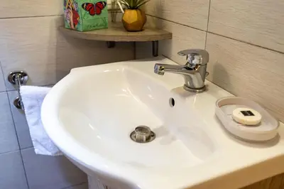 a white sink in a bathroom with a towel at 