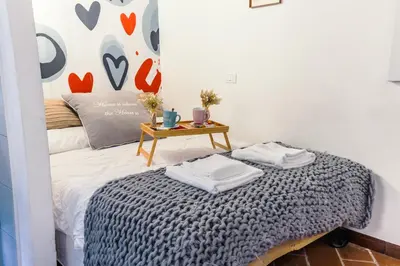 a bedroom with a bed with a table on it at 