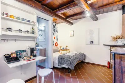 a room with a bed and a table and chairs at 