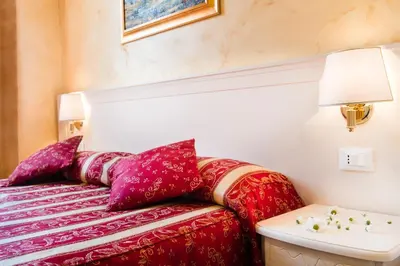 a red couch with purple pillows in a room at Domus Trevi in Rome