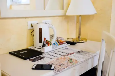 a coffee maker sitting on a desk with a lamp at Domus Trevi in Rome