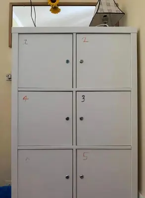 a white cabinet with numbers on it in a room at Qiyuan Hotel in Rome
