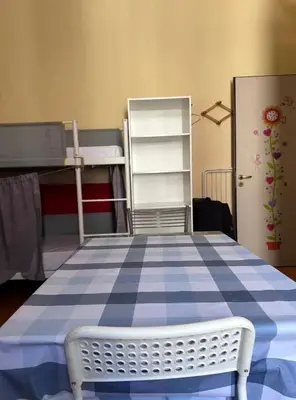 a bed with a blue and white checkered floor in a room at Qiyuan Hotel in Rome