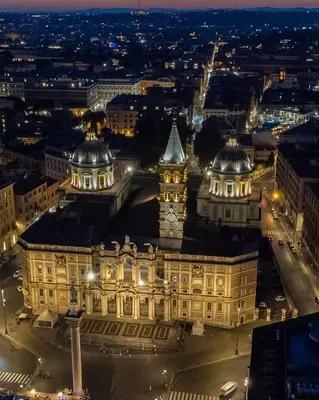 a large building with a clock tower at night at Jumbo Inn in Rome