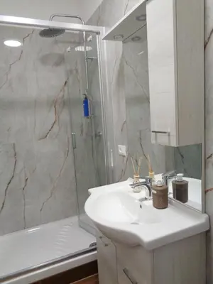 a bathroom with a sink and a shower at Jumbo Inn in Rome