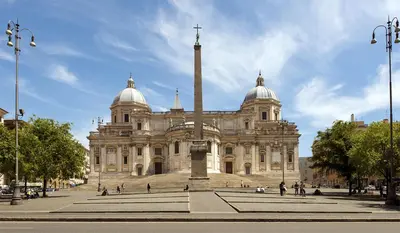 a large building with a cross in front of it at Jumbo Inn in Rome