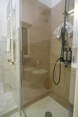 a bathroom with a shower with a sink and a toilet at Via Lattea Vatican Apartment - Family friendly in Rome