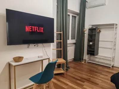 a living room with a television on a wall at Via Lattea Vatican Apartment - Family friendly in Rome