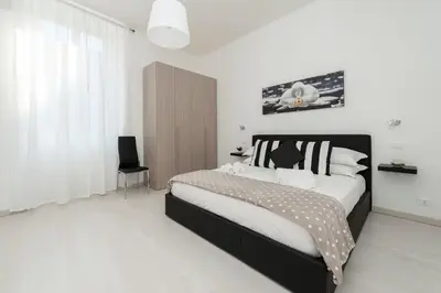 a bedroom with a black and white bed and a window at White Flat Termini in Rome