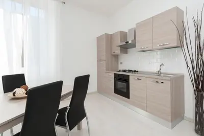 a kitchen with a table and chairs and a sink at White Flat Termini in Rome