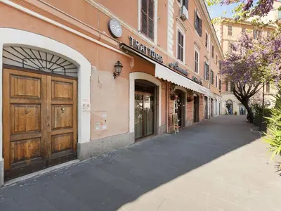 a building with a large wooden door on a street at White Flat Termini in Rome