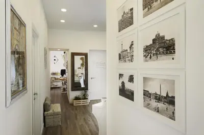 a hallway with black and white pictures on the walls at Vaticano Charming Rooms in Rome