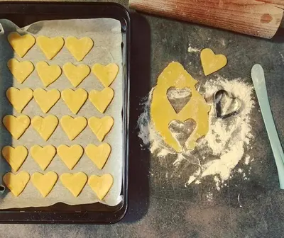 a pan filled with heart shaped cookies on a table at Vaticano Charming Rooms in Rome