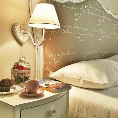 a bed with a chalkboard wall with writing on it at Vaticano Charming Rooms in Rome