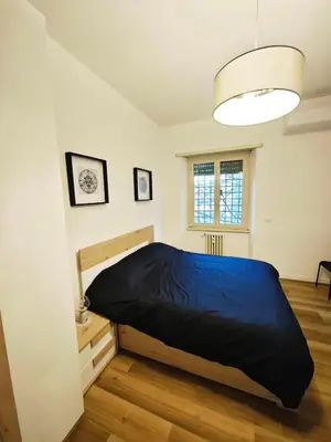 a bedroom with a large bed in a room at DOMUS Villa Chigi in Rome