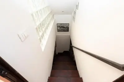 a staircase in a building with white walls and wooden floors at San Pietro Terrace Apartment in Rome