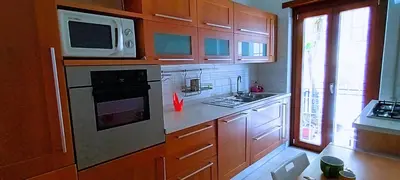a kitchen with a microwave and a stove top oven at Leila Stazione Tiburtina 10 minuti dal Coloseo in Rome