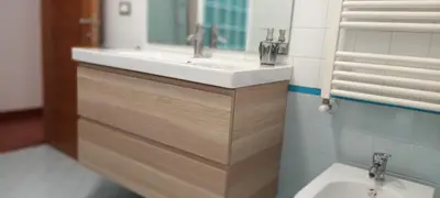 a bathroom with a sink and a mirror at Leila Stazione Tiburtina 10 minuti dal Coloseo in Rome