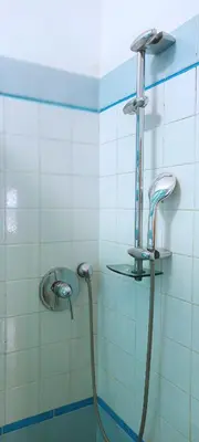 a shower in a bathroom with a hose at Leila Stazione Tiburtina 10 minuti dal Coloseo in Rome