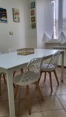 a white table and two chairs sitting at a table at A casa di Tommy in Rome