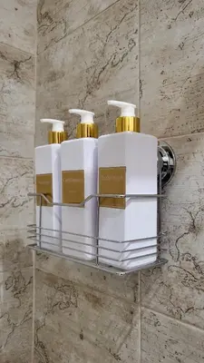 three bottles ofodorizers sit on a shelf in a bathroom at A casa di Tommy in Rome