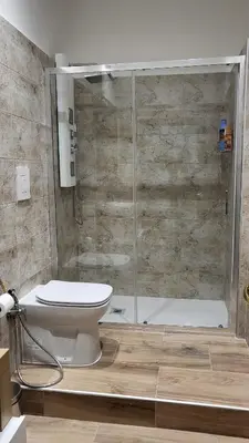 a bathroom with a shower and a toilet and a tub at A casa di Tommy in Rome