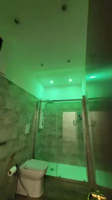 a bathroom with a toilet and a glass shower at A casa di Tommy in Rome