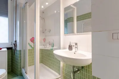 a bathroom with a sink and a shower at Artistic colorful Apart Vatican Museums in Rome