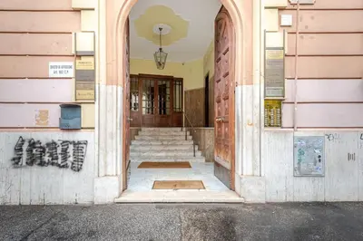 a hallway of a building with stairs and a door at Artistic colorful Apart Vatican Museums in Rome